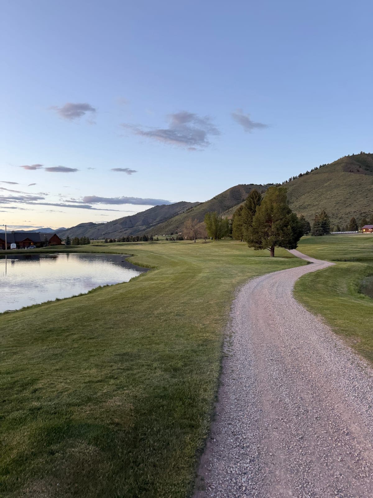Valley Vu Golf Course at dusk, with a pond and mountains